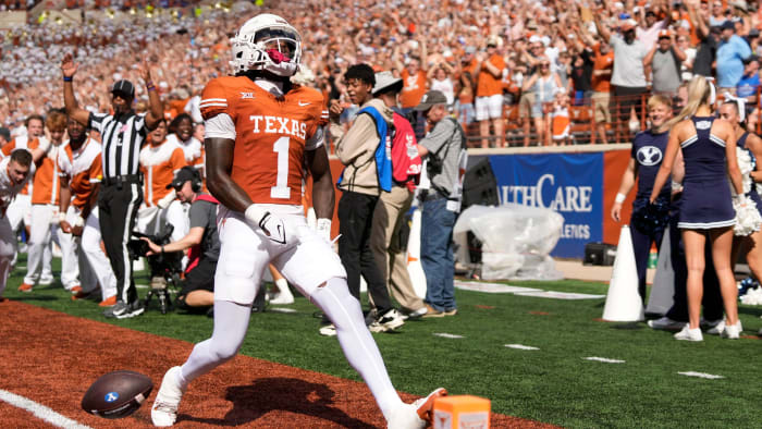 Texas Longhorns punt returner Xavier Worthy scores a touchdown on a punt return against the BYU Cougars.