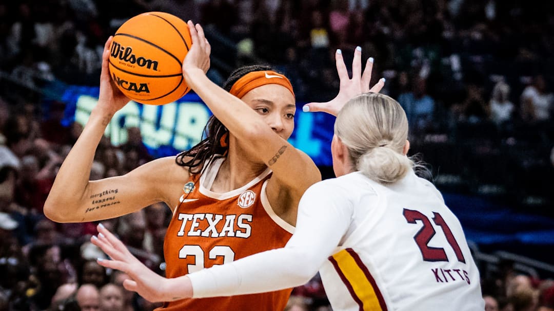 Texas Longhorns guard Ndjakalenga Mwenentanda (32) protects the ball from South Carolina Gamecocks forward Chloe Kitts (21) in the second half of the Longhorns' NCAA Playoff semi-final game against the South Carolina Gamecocks at Amalie Arena in Tampa, Florida, April 4, 2025.