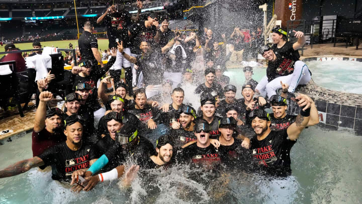 The Arizona Diamondbacks players celebrate in the outfield pool after clinching a wild card playoff spot following their game with the Houston Astros at Chase Field on Sept. 30, 2023.