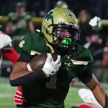 Xavier Baker (1) of the Bishop Feehan runs the ball against Bridgewater-Raynham in the MIAA Division II semifinals over the weekend.