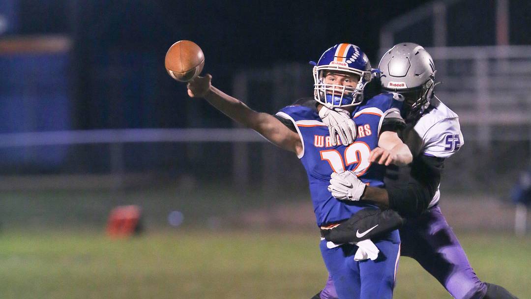 Joppatowne's Zion Elee wraps up Boonsboro QB Colin Telemeco as he releases the ball.