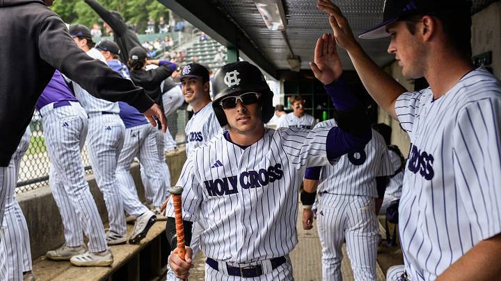 Holy Cross outfielder CJ Egrie, center, celebrates with the dugout after scoring on a double by Chris Baillargeon in the bottom of the seventh inning versus Army on Sunday May 18, 2025 at Fitton Field in Worcester.