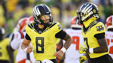 Oct 26, 2024; Eugene, Oregon, USA; Oregon Ducks quarterback Dillon Gabriel (8) celebrates with wide receiver Evan Stewart (7) after scoring a touchdown during the first half against Illinois Fighting Illini at Autzen Stadium. Mandatory Credit: Troy Wayrynen-Imagn Images