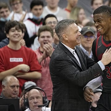 Ohio State Buckeyes forward E.J. Liddell (32) gets a pat on the shoulder from head coach Chris Holtmann during the second half of the NCAA men's basketball game at Value City Arena in Columbus on Saturday, Dec. 11, 2021. The Buckeyes won 73-55.