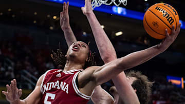 Indiana Hoosiers forward Malik Reneau (5) drives and makes the bucket Thursday, March 13, 2025, against Oregon Ducks center Nate Bittle (32) during the 2025 TIAA Big Ten Men’s Basketball Tournament at Gainbridge Fieldhouse in Indianapolis.