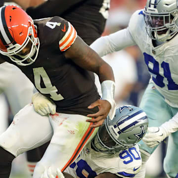 Cleveland Browns quarterback Deshaun Watson (4) fumbles the ball as he is tackled by Dallas Cowboys defensive end DeMarcus Lawrence (90) during the second half of an NFL football game at Huntington Bank Field, Sunday, Sept. 8, 2024, in Cleveland, Ohio.