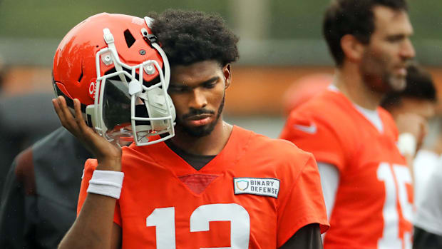 Cleveland Browns quarterback Shedeur Sanders (12) listens to the play calling on the sideline during an NFL practice at the C