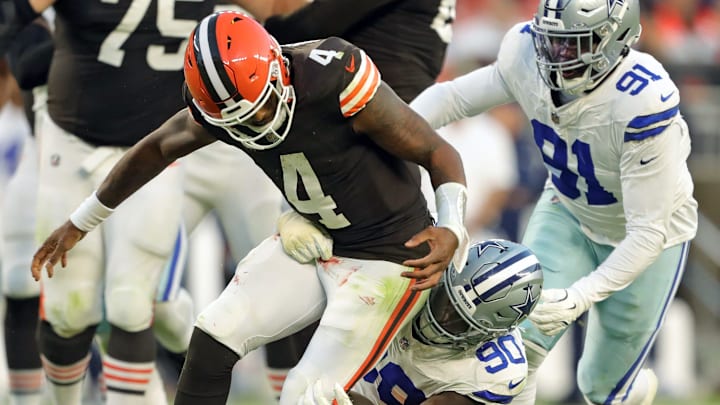 Cleveland Browns quarterback Deshaun Watson (4) fumbles the ball as he is tackled by Dallas Cowboys defensive end DeMarcus Lawrence (90) during the second half of an NFL football game at Huntington Bank Field, Sunday, Sept. 8, 2024, in Cleveland, Ohio.