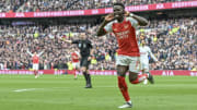 Arsenal stayed in the hunt with victory at Tottenham