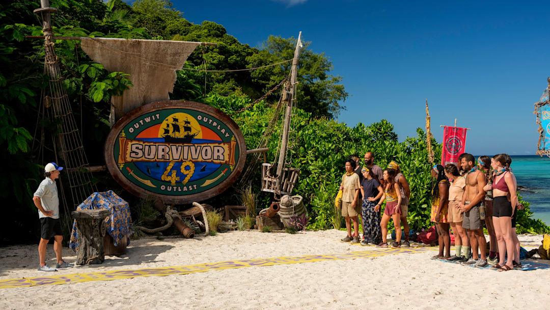 “I’m a Wolf, Baby” – One castaway’s scheming gets them into hot water when their tribe realizes the same conversation has been repeated to each of them. Two castaways are sent on a grueling journey. Then, one castaway’s series of missteps leaves one of their tribemates hungry for revenge, on SURVIVOR, Wednesday, Oct. 22. Pictured (L-R): Jeff Probst and Survivor 49 contestants. Photo: Robert Voets/CBS ©2025 CBS Broadcasting, Inc. All Rights Reserved.