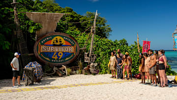 “I’m a Wolf, Baby” – One castaway’s scheming gets them into hot water when their tribe realizes the same conversation has been repeated to each of them. Two castaways are sent on a grueling journey. Then, one castaway’s series of missteps leaves one of their tribemates hungry for revenge, on SURVIVOR, Wednesday, Oct. 22. Pictured (L-R): Jeff Probst and Survivor 49 contestants. Photo: Robert Voets/CBS ©2025 CBS Broadcasting, Inc. All Rights Reserved.