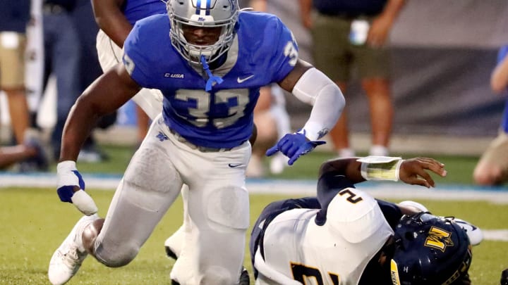 MTSU linebacker Sam Brumfield (33) celebrates sacking Murray State quarterback DJ Williams (2) during a football game at MTSU's Floyd Stadium on Saturday, Sept. 16, 2023.