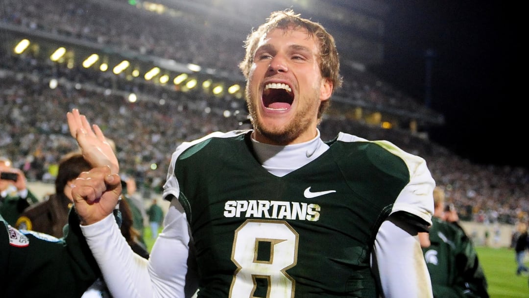Oct 22, 2011; East Lansing, MI, USA; Michigan State Spartans quarterback Kirk Cousins (8) celebrates after throwing a hail mary pass as the clock expired to defeat the Wisconsin Badgers 37-31 at Spartan Stadium. Mandatory Credit: Andrew Weber- USA TODAY Sports