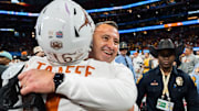 Texas Longhorns head coach Steve Sarkisian embraces Texas Longhorns defensive back Michael Taaffe (16) as they celebrate their win in the Peach Bowl College Football Playoff quarterfinal against Arizona State at Mercedes-Benz Stadium in Atlanta, Georgia, Jan. 1, 2025.