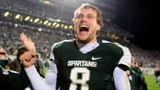 Oct 22, 2011; East Lansing, MI, USA; Michigan State Spartans quarterback Kirk Cousins (8) celebrates after throwing a hail mary pass as the clock expired to defeat the Wisconsin Badgers 37-31 at Spartan Stadium. Mandatory Credit: Andrew Weber- USA TODAY Sports