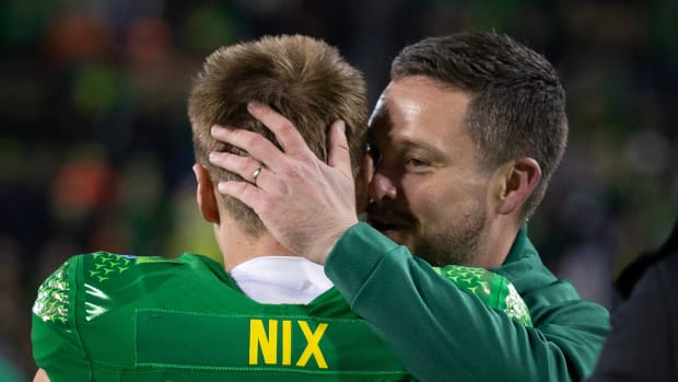 Oregon   s Bo Nix and coach Dan Lanning embrace before the game against Oregon State 