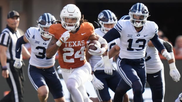 Texas Longhorns running back Jonathon Brooks runs past BYU Cougars defenders in the third quarter at