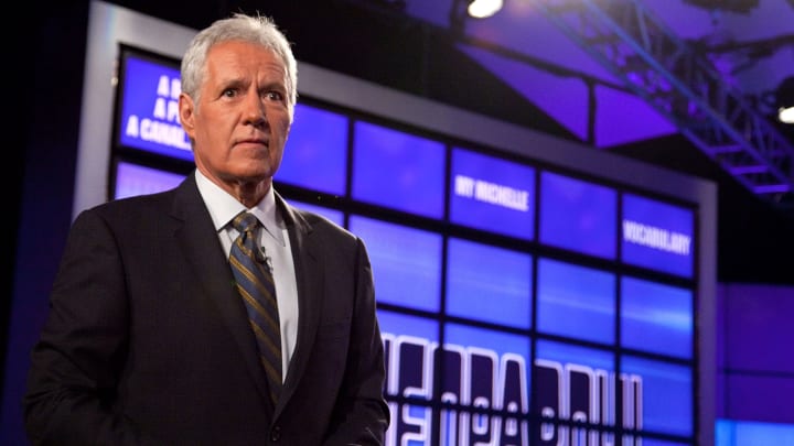 Alex Trebek is shown shortly before shaking his head in disappointment at a contestant.