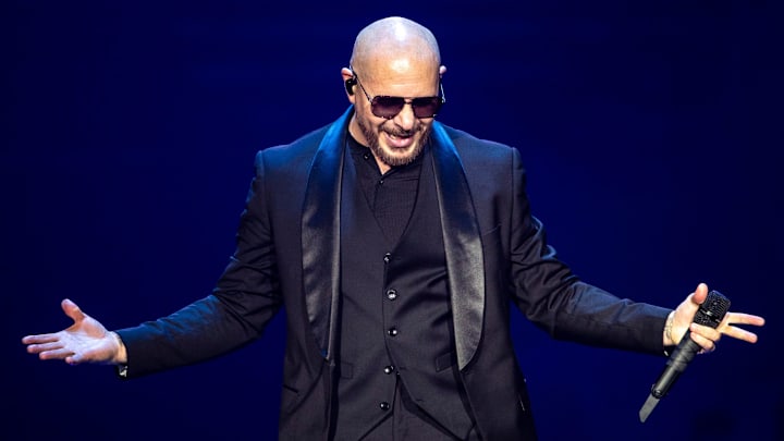 Pitbull gestures to the crowd after a song during The Trilogy Tour at Acrisure Arena in Palm Desert, Calif.