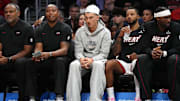 Oct 8, 2025; Miami, Florida, USA;  Miami Heat guard Tyler Herro, center, watches the game against the San Antonio Spurs from the bench at Kaseya Center as he recovers from an injury. Mandatory Credit: Jim Rassol-Imagn Images