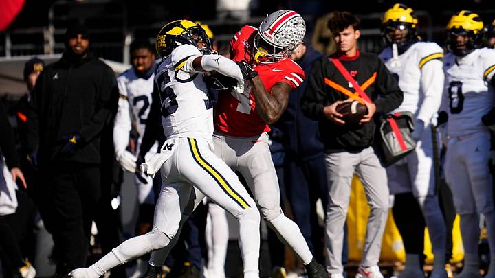 Michigan Wolverines defensive back Jyaire Hill (35) tackles Ohio State Buckeyes wide receiver Jeremiah Smith (4) during the first half of the NCAA football game at Ohio Stadium in Columbus on Saturday, Nov. 30, 2024.