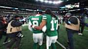 Jan 5, 2025; East Rutherford, New Jersey, USA; New York Jets quarterback Aaron Rodgers (8) and wide receiver Davante Adams (17) walk on the field after the Jets win over the Miami Dolphins at MetLife Stadium. Mandatory Credit: Ed Mulholland-Imagn Images