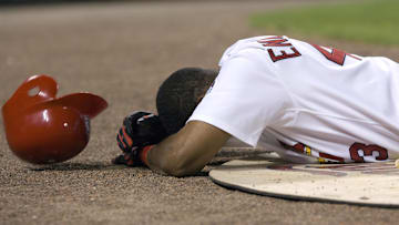 St. Louis Cardinals pinch hitter Juan Encarnacion (43) lies motionless after being hit in the face by a foul ball