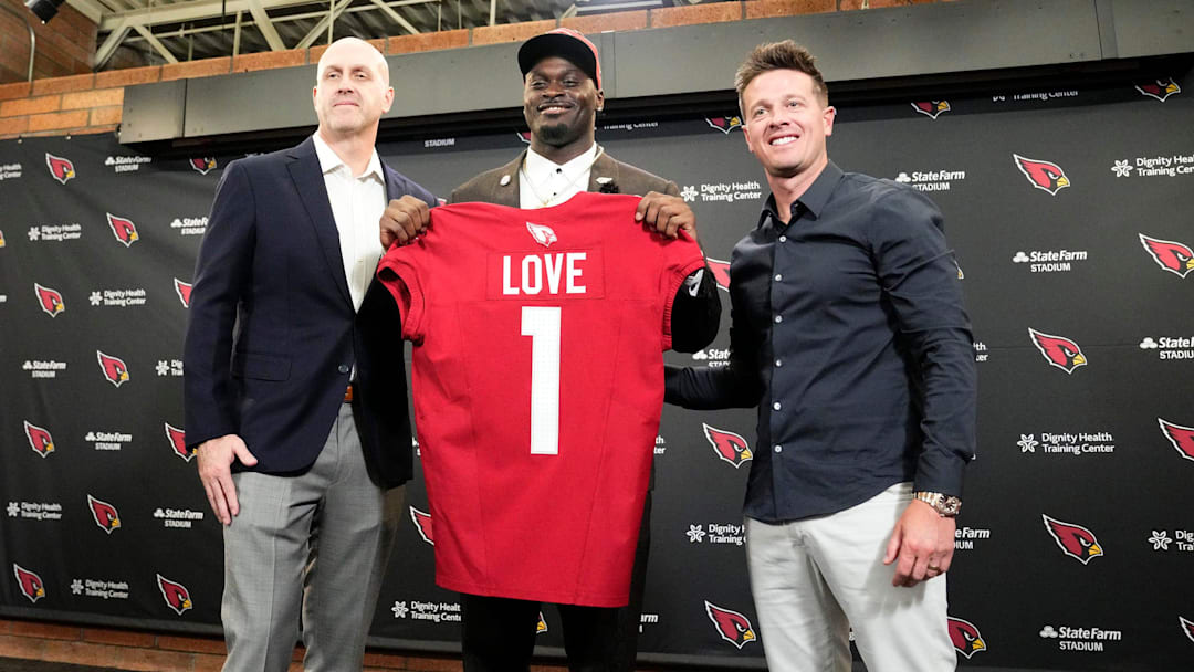 Arizona Cardinals general manager Monti Ossenfort and head coach Mike LaFleur (right) introduce their first-round draft pick running back Jeremiyah Love during a news conference at the Cardinals Dignity Health training facility on April 24, 2026, in Tempe, Ariz.