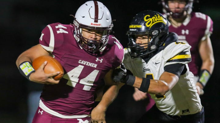 Mishawaka's Chase Gooden (44) attempting to evade Fort Wayne Snider's Brandon Logan (4) during Friday nights Regional game at Mishawaka. Fort Wayne Snider Mishawaka Football