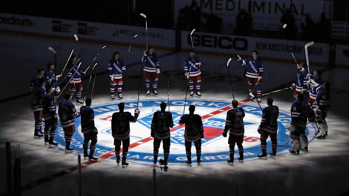 Jan 14, 2021; New York, NY, USA;  New York Rangers players huddle around the center ice logo as they prepare for the home opener against the New York Islanders at Madison Square Garden.  