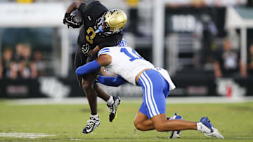 Oct 26, 2024; Orlando, Florida, USA;  Central Brigham Young Cougars saftey Faletau Satuala (10) tackles Florida Knights wide receiver Ja'Varrius Johnson (9) during the second half at FBC Mortgage Stadium. Mandatory Credit: Russell Lansford-Imagn Images