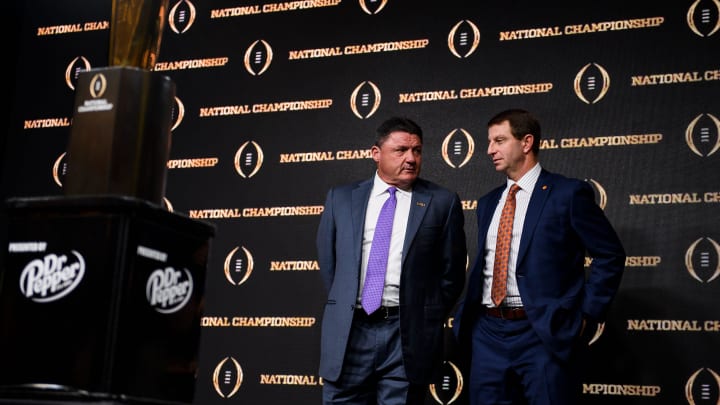 Clemson head coach Dabo Swinney and LSU head coach Ed Orgeron stand next to each other during a