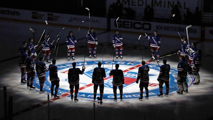 Jan 14, 2021; New York, NY, USA;  New York Rangers players huddle around the center ice logo as they prepare for the home opener against the New York Islanders at Madison Square Garden.  