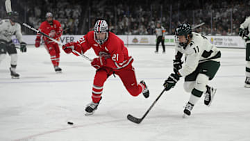 Joe Dunlap defends against MSU's Owen West, Saturday, March 22, 2025, during the third period of the Big 10 Hockey final at Munn Ice Arena. MSU won 4-3 in double overtime.