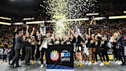 The Iowa Hawkeyes celebrate with the trophy after defeating the Nebraska Cornhuskers in the Big Ten Conference Tournament Championship at Target Center.  