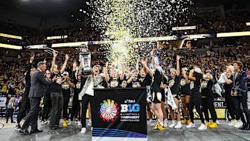 The Iowa Hawkeyes celebrate with the trophy after defeating the Nebraska Cornhuskers in the Big Ten Conference Tournament Championship at Target Center.  