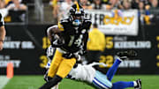 Oct 6, 2024; Pittsburgh, Pennsylvania, USA; Pittsburgh Steelers wide receiver George Pickens (14) breaks a tackle by Dallas Cowboys cornerback Jourdan Lewis (2) during the first quarter at Acrisure Stadium. Mandatory Credit: Barry Reeger-Imagn Images






