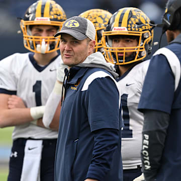 Kirtland football coach Tiger LaVerde meets with his team during the 2023 state championship game.