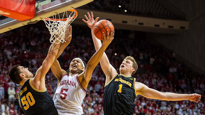 Indiana's Malik Reneau (5) scores between Valdislav Goldin (50) and Danny Wolf (1) during the Indiana versus Michigan mens basketball game at Simon Skjodt Assembly Hall on Saturday, Feb. 8, 2025.