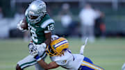 De La Salle senior cornerback Ant Deen rolls in for a touchdown after stripping quarterback Luke Alexander of the ball, giving the Spartans a 35-7 lead. 