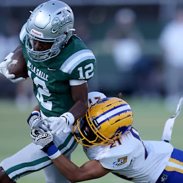 De La Salle senior cornerback Ant Deen rolls in for a touchdown after stripping quarterback Luke Alexander of the ball, giving the Spartans a 35-7 lead. 