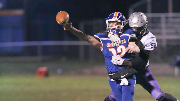 Joppatowne's Zion Elee wraps up Boonsboro QB Colin Telemeco as he releases the ball. Elee is now at St. Frances Academy.