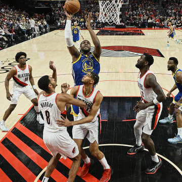 Apr 11, 2024; Portland, Oregon, USA; Golden State Warriors forward Kevon Looney (5) puts up a shot during the second half against Portland Trail Blazers center Deandre Ayton (2) at Moda Center. Mandatory Credit: Troy Wayrynen-USA TODAY Sports