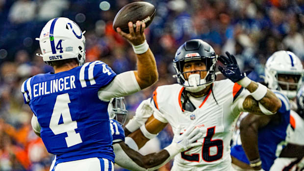 Indianapolis Colts quarterback Sam Ehlinger (4) throws a pass over Denver Broncos safety Devon Key (26).