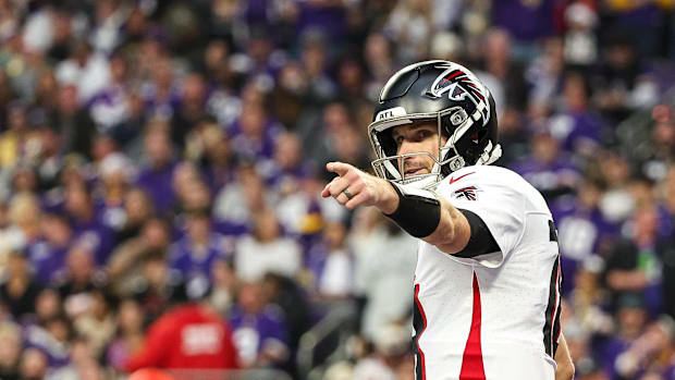 Dec 8, 2024; Minneapolis, Minnesota, USA; Atlanta Falcons quarterback Kirk Cousins (18) celebrates running back Bijan Robinso