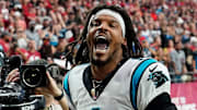 Former NFL quarterback Cam Newton yells \"I'm back!\" after scoring a touchdown for the Carolina Panthers