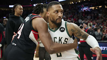 Jan 31, 2024; Portland, Oregon, USA; Milwaukee Bucks guard Damian Lillard (0) embraces Portland Trail Blazers forward Jabari Walker (34) after a game at Moda Center. Mandatory Credit: Troy Wayrynen-Imagn Images