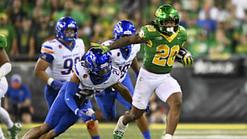 Sep 7, 2024; Eugene, Oregon, USA; Oregon Ducks running back Jordan James (20) picks up a first down during the second half as he breaks away from Boise State Broncos safety Zion Washington (21) at Autzen Stadium. Mandatory Credit: Troy Wayrynen-Imagn Images