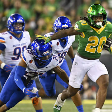 Sep 7, 2024; Eugene, Oregon, USA; Oregon Ducks running back Jordan James (20) picks up a first down during the second half as he breaks away from Boise State Broncos safety Zion Washington (21) at Autzen Stadium. Mandatory Credit: Troy Wayrynen-Imagn Images