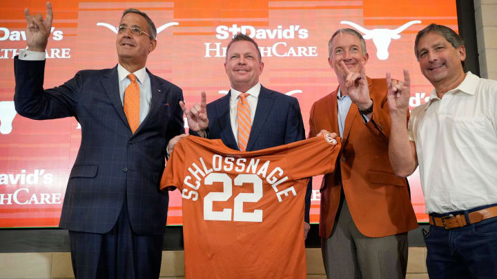 University of Texas baseball coach Jim Schlossnagle, second from left, is joined by UT Athletic Director Chris Del Conte, left to right, President Jay Hartzell and Chairman of the Board of Regents Kevin Eltife at his introductory news conference at the Frank Denius Family University Hall of Fame Wednesday June 26, 2024.